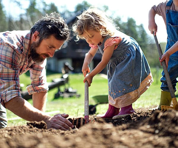 Dad and Kids Planting Tree